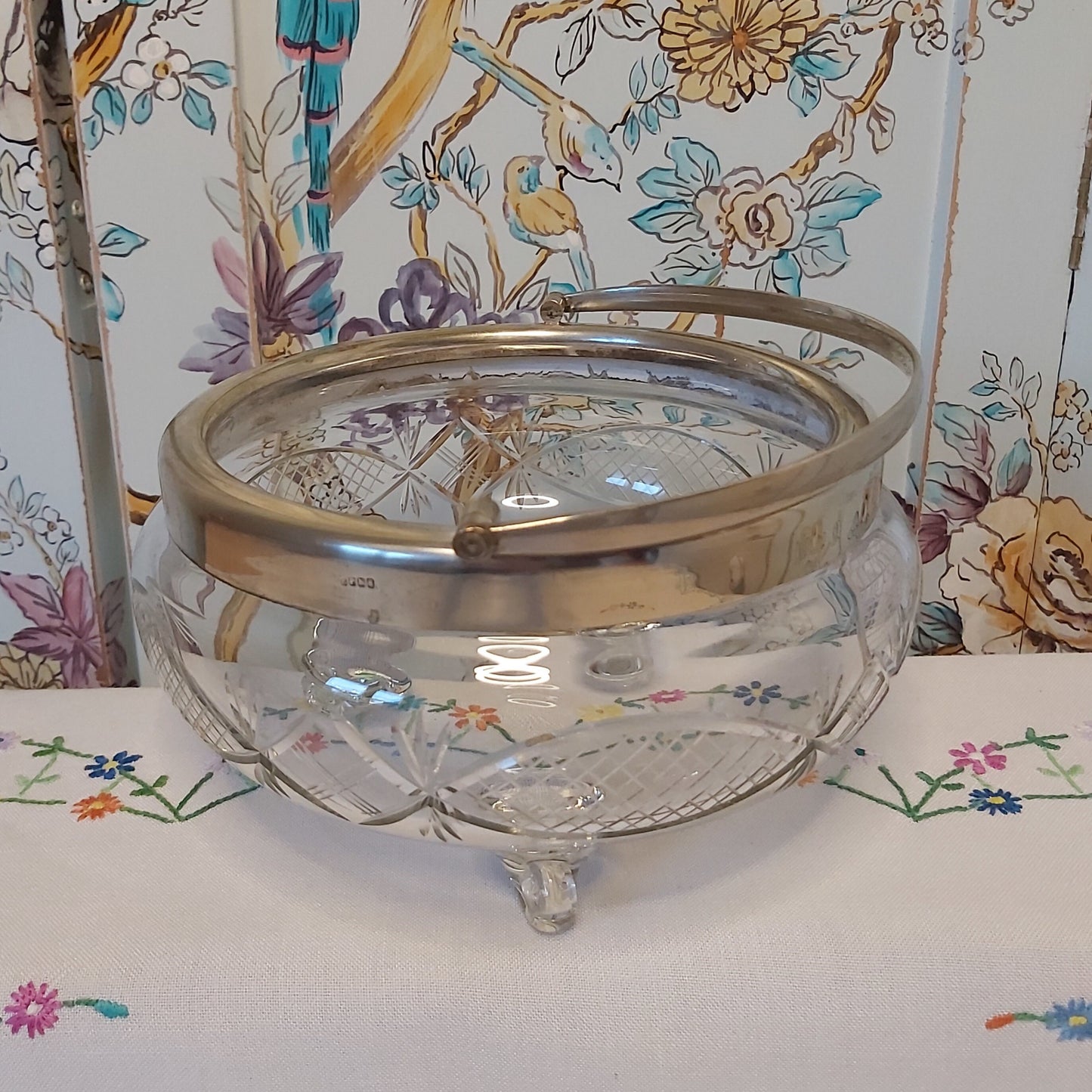 A Large Antique Cut Glass Bowl with Silver Plated Mounts and Swing Handle