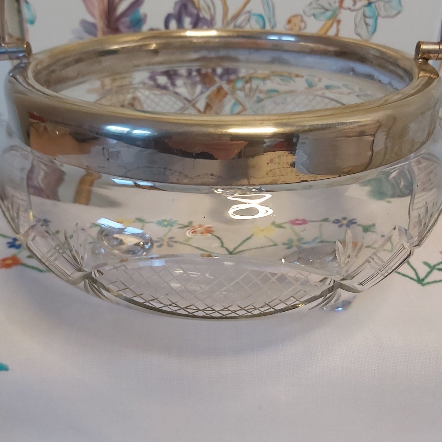 A Large Antique Cut Glass Bowl with Silver Plated Mounts and Swing Handle
