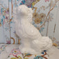 An Antique White Mantle Dog