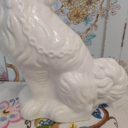 An Antique White Mantle Dog