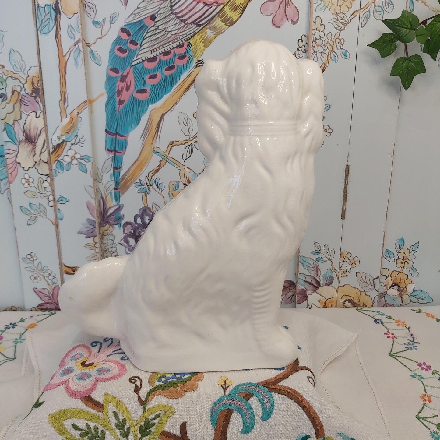 An Antique White Mantle Dog