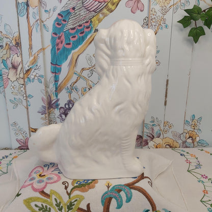 An Antique White Mantle Dog
