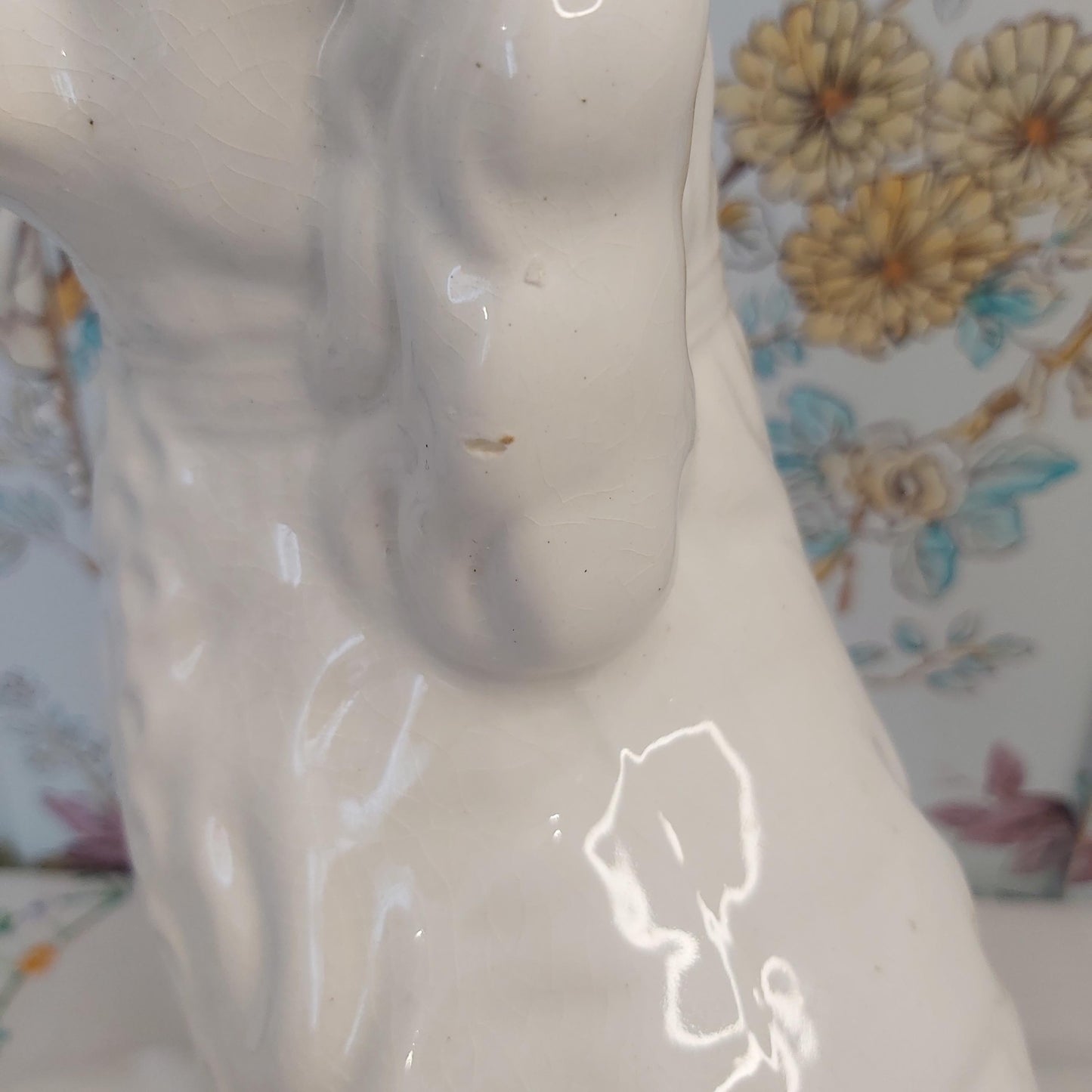 An Antique White Mantle Dog