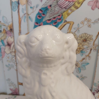 An Antique White Mantle Dog